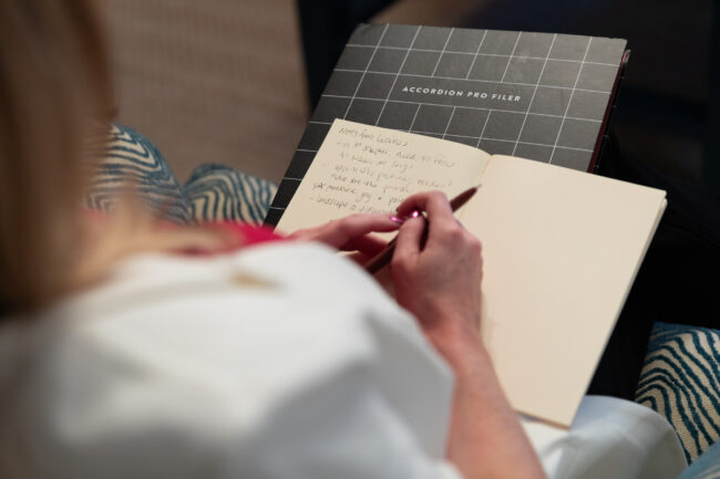 Author writes in notebook